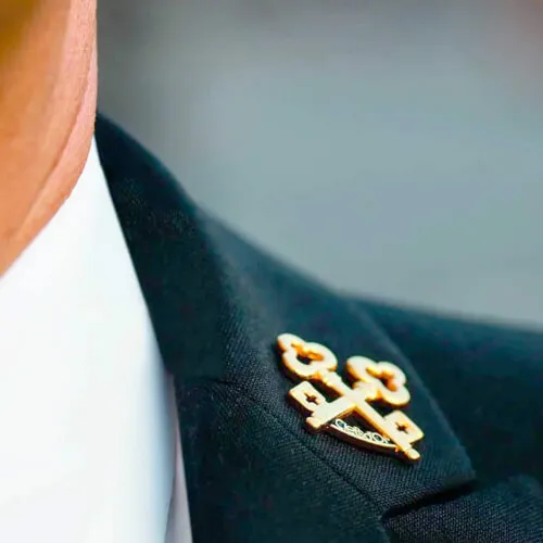 Pin on suit representing 7Pines Resort Ibiza's commitment to excellence in concierge services