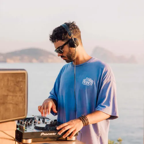 DJ playing music at 7Pines Resort Ibiza, capturing the essence of island's vibrant DJ sessions and live music ambiance.